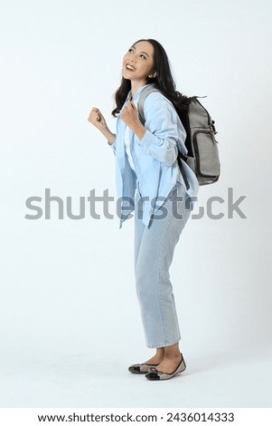 backview full leght shoot of happy asian Indonesian woman wearing casual attire and backpack on isolated background