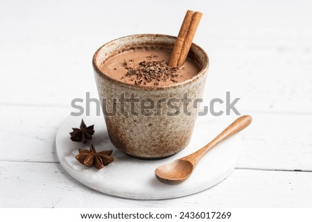 Mexican drink Champurrado on a white wooden background, selective focus Royalty-Free Stock Photo #2436017269