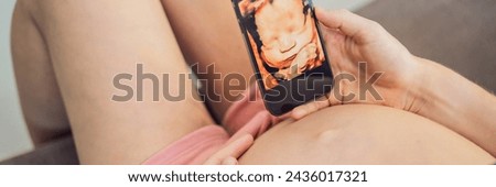 Pregnant woman holding and showing mobile phone with fetal ultrasound photo BANNER, LONG FORMAT