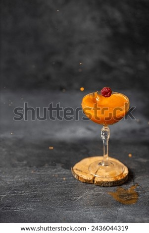 liquid splash in cocktail glass on dark stone background