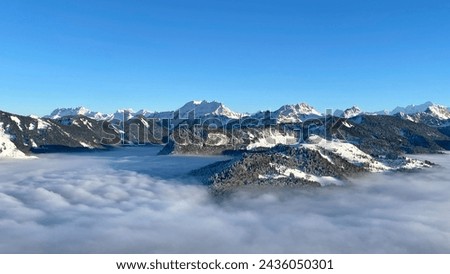 Snow-capped alpine peaks above the clouds