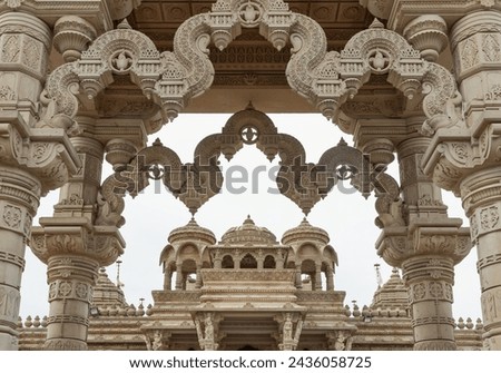 Entrance archway of The Shree Sanatan Hindu Mandir Hindu Temple (The Shri Sanatan Hindu Temple). Gates of Neasden Temple build from Elaborately carved Jaisalmer limestone,  Royalty-Free Stock Photo #2436058725