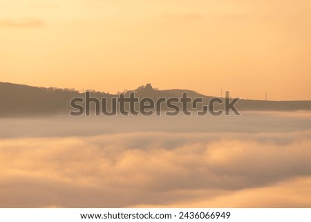 Castle over the fog in sunrise, beautiful low clouds inversion in sunrise, cloud sea Royalty-Free Stock Photo #2436066949