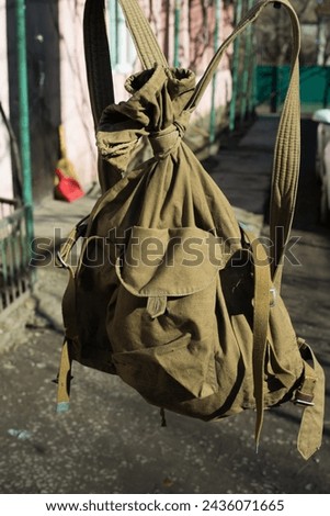 an old army bag on the background of yard