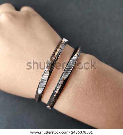 Exquisite diamond and gold bangles, epitomizing elegance and luxury. Crafted with precision and adorned with brilliance, a timeless adornment for any occasion. Royalty-Free Stock Photo #2436078501