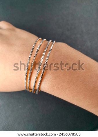 Exquisite diamond and gold bangles, epitomizing elegance and luxury. Crafted with precision and adorned with brilliance, a timeless adornment for any occasion. Royalty-Free Stock Photo #2436078503