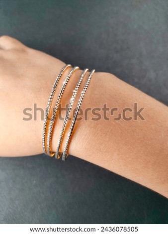 Exquisite diamond and gold bangles, epitomizing elegance and luxury. Crafted with precision and adorned with brilliance, a timeless adornment for any occasion. Royalty-Free Stock Photo #2436078505