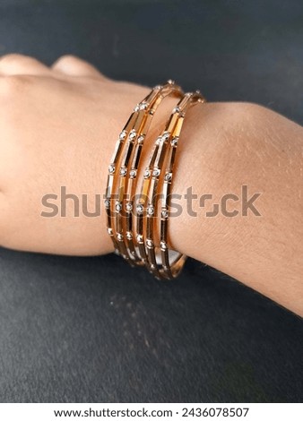 Exquisite diamond and gold bangles, epitomizing elegance and luxury. Crafted with precision and adorned with brilliance, a timeless adornment for any occasion. Royalty-Free Stock Photo #2436078507