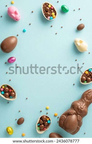 Lovely Easter collection theme. Top view vertical photo of fragmented chocolate eggs, overflowing with colorful candies, chocolate bunny, sprinkles on light blue backdrop, with area for text or advert