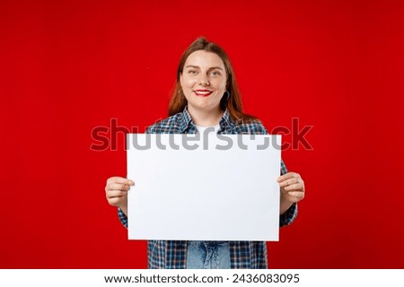 Beautiful 30s woman holding a blank advertisement banner isolated over red background. Young woman holding sign business board