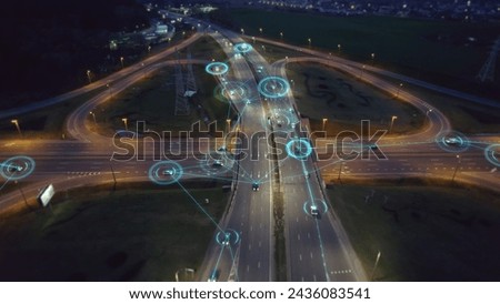 Self-driving autonomous cars move along a suburban traffic intersection in the evening. Neon HUD elements visualize the interaction of driverless cars connected to a common network	

 Royalty-Free Stock Photo #2436083541