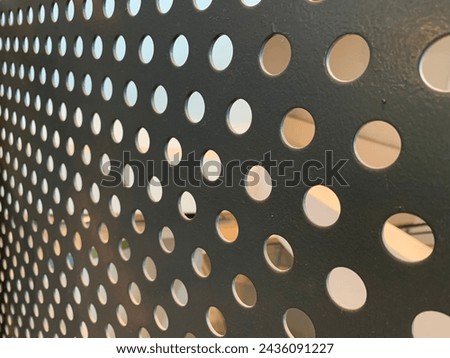 Perforated metal texture background frame with holes