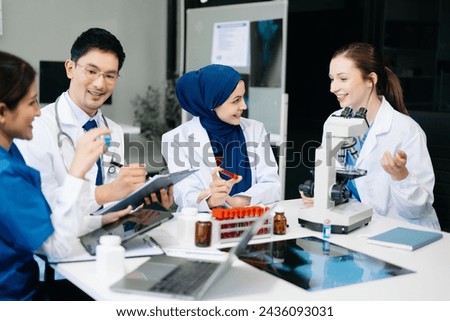  Doctor Talks With Professional Head Nurse or Surgeon, They Use Digital tablet Computer. Diverse Team of Health Care Specialists Discussing Test Result on desk in hospital 
