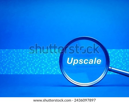 Upscale concept. Word "Upscale" in magnifying glass lens on blue background with copy space. Artificial intelligence algorithms to increase resolution of image, enhancing details and pixel quality.