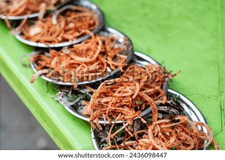 Tasty salads  made from onions and dry pepper on a green table, close up, outdoor photography
