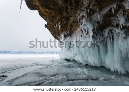 Coast of lake Baikal in winter, the deepest and largest freshwater lake by volume in the world, located in southern Siberia, Russia Royalty-Free Stock Photo #2436115219