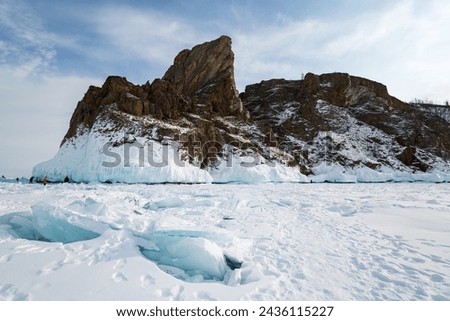 Coast of lake Baikal in winter, the deepest and largest freshwater lake by volume in the world, located in southern Siberia, Russia Royalty-Free Stock Photo #2436115227
