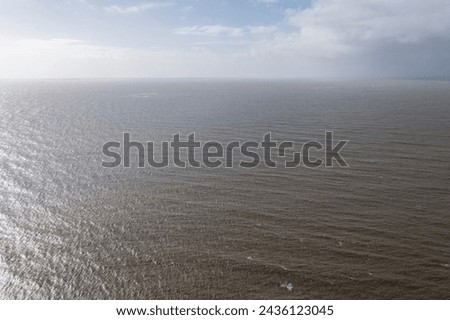 A landscape of a beautiful and calm ocean, without waves, safe for sailing.