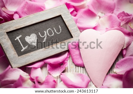 Pink rose petals with the words "I love you" and heart.