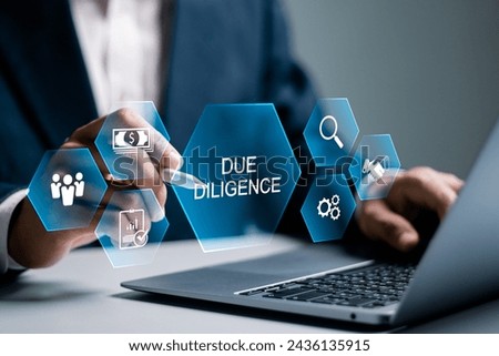 Due diligence concept. Businessman using laptop with due diligence icon on virtual screen. Royalty-Free Stock Photo #2436135915