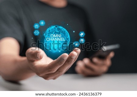 Omni Channel concept. Person holding globe with omni channel icons on virtual screen for business and social media marketing. Royalty-Free Stock Photo #2436136379