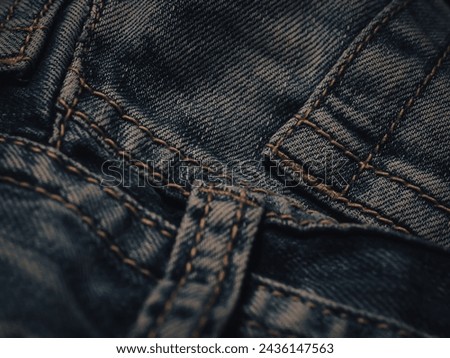 Dark jeans texture at night for a super cool fashion background.  Royalty-Free Stock Photo #2436147563