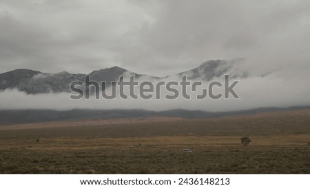 Breathtaking Cloudy background with mountains open fields and road 