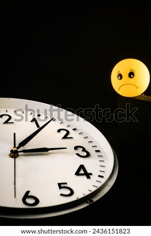 Late, insomnia, time is up illustration, yellow rubber toy with face expression on watch background.