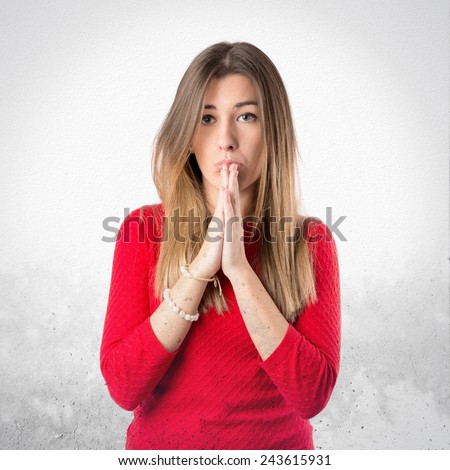 Cute young girl pleading over textured background 