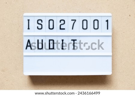 Lightbox with word ISO 270001 audit on wood background