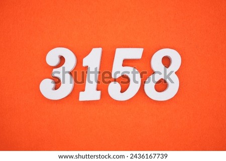 Orange felt is the background. The numbers 3158 are made from white painted wood.