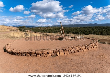 Entrance to a kiva at Pecos National Historic Site. Round underground Pueblo Indian ceremonial structure. Many Pueblo people see kiva as a depiction of their universe. Royalty-Free Stock Photo #2436169191