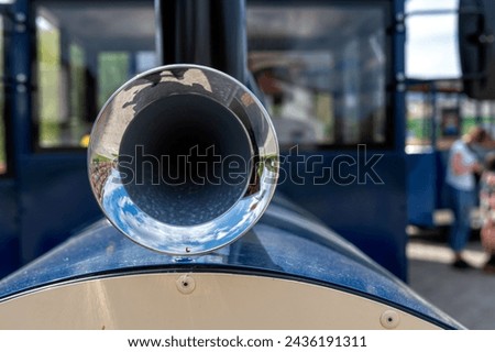Close-up of the steel vintage signal horn on a blue car in the park, selective focus Royalty-Free Stock Photo #2436191311