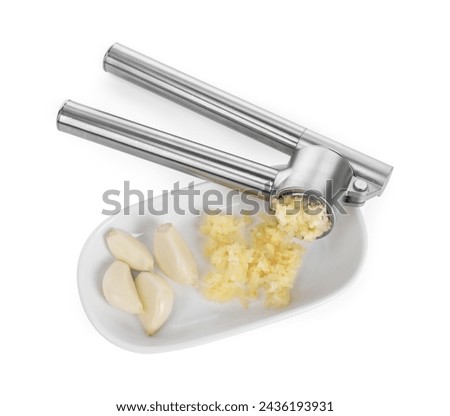 One metal press and garlic isolated on white, top view Royalty-Free Stock Photo #2436193931