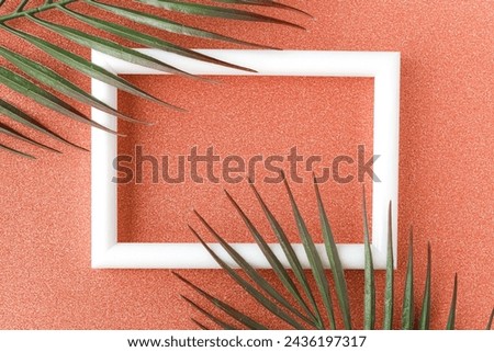 White photo frame on orange glitter background with pattern. Modern template for designer