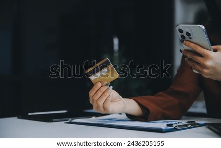 Hands holding plastic credit card and using laptop. Online shopping concept. Toned picture