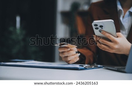 Hands holding plastic credit card and using laptop. Online shopping concept. Toned picture