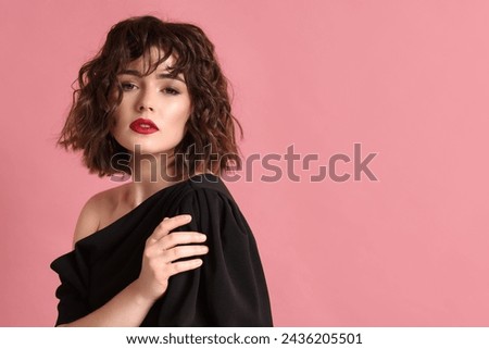 Portrait of beautiful young woman with wavy hairstyle on pink background. Space for text