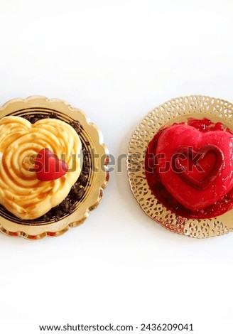 Two heart - shaped Valentine's day dessert isolated on white background. Valentine's day celebration. Overhead view. Copy space. 