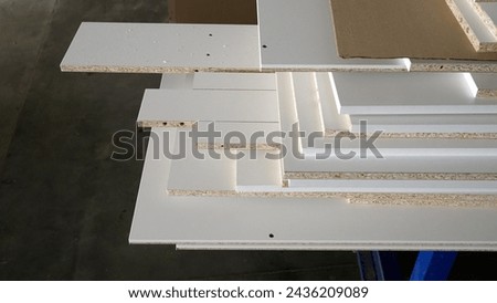 Samples of chipboard and MDF panels for furniture production. Samples of finishing material based on chipboard and MDF, close-up. Furniture production in a hardware store or furniture showroom.