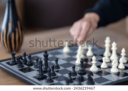 Playing chess on the table. Image with blurred background.