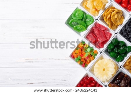 Group of dried and candied fruit in bowl . Top view