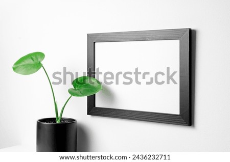 Landscape picture frame mockup with home plant