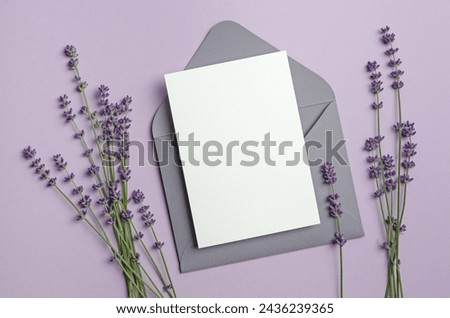 Invitation or greeting card mockup with envelope and lavender flowers, blank mockup with copy space