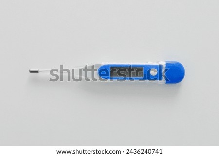Blue electronic modern thermometer on white background Royalty-Free Stock Photo #2436240741