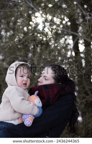 Mother and son in outdoor winter settng Royalty-Free Stock Photo #2436244365