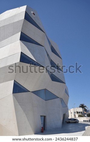 Modern architecture building picture with irregular shaped walls and windows white facade
