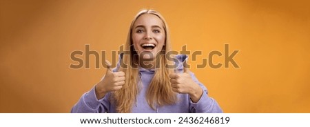 Supportive cute blond girlfriend cheering liking interesting concept cool idea thumbs-up smiling broadly agree approve outfit shopping together friends, recommend adore new look, orange background. Royalty-Free Stock Photo #2436246819