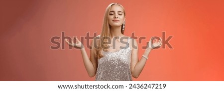 Keep calm party all night. Carefree unbothered happy charming stress-free blond young woman in stylish dress smiling relieved close eyes rejoicing standing lotus nirvana pose, breathing meditating.