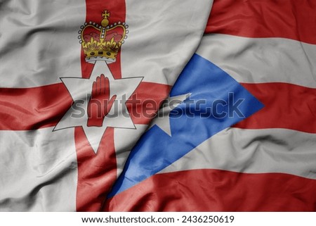 big waving national colorful flag of puerto rico and national flag of northern ireland . macro